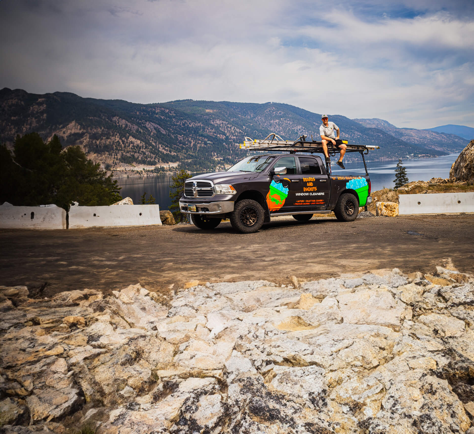 Duff Wallace from Beards And Buckets Seated on Pickup Truck with Mountain View